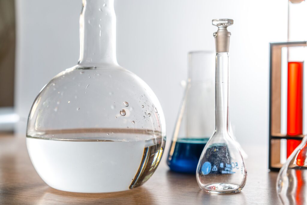 Close-up of laboratory glassware with various chemical solutions in a lab setting.